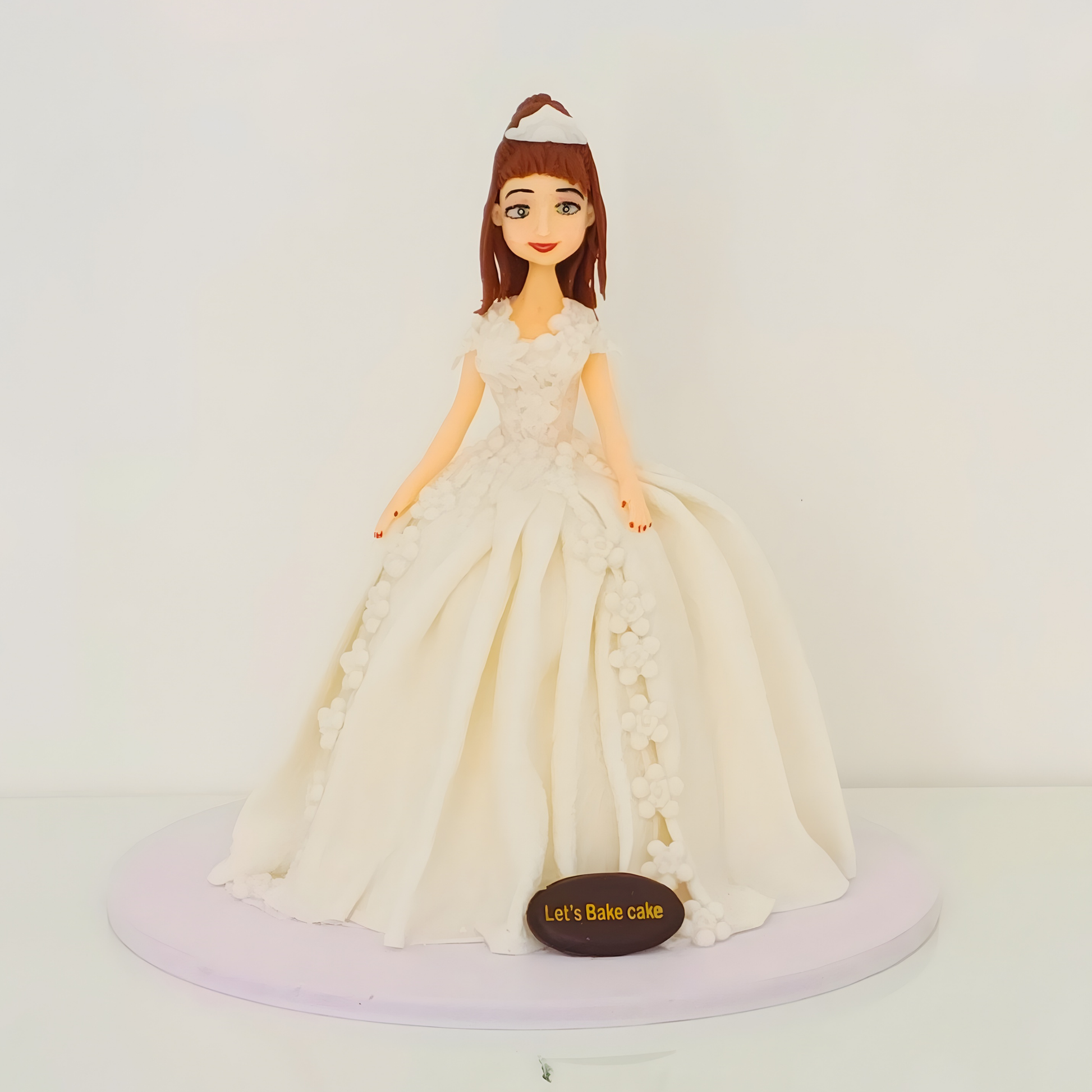 A premium 3D princess doll birthday cake featuring an intricate ivory fondant gown with floral detailing by Let's Bake Cake Abu Dhabi.