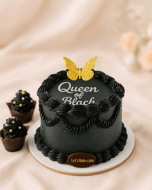 A luxury matte black birthday cake with 'Queen of Black' lettering, golden butterfly topper, and matching cupcakes by Let's Bake Cake Abu Dhabi